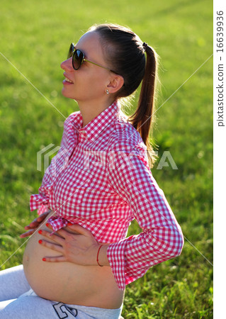 Pregnant woman outdoors 16639936