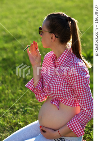 Pregnant woman outdoors 16639937