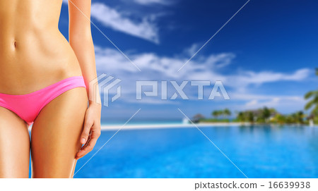 Woman at tropical swimming pool 16639938