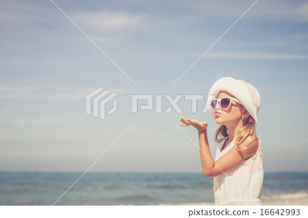 Little girl  standing on the beach 16642993