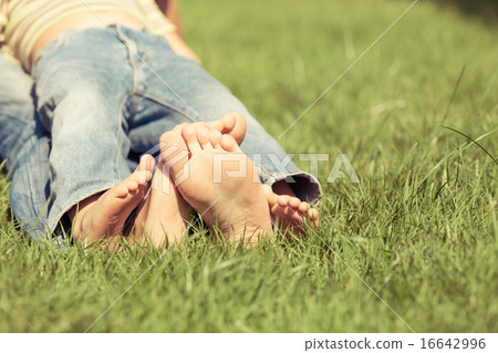 Father and son sitting on the grass at the day time. Father and son sitting on the grass at the day time. 16642996