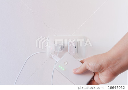 female hand plugging in the plug of her power bank female hand plugging in the plug of her power bank 16647032