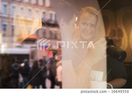 Man Showing Photos in Camera 16649358