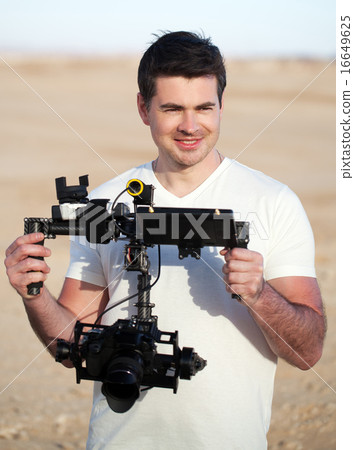 Smiling man with steadicam equipment outdoor 16649625