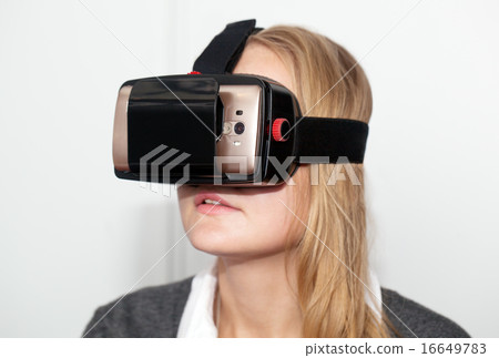Woman wearing VR-headset over white background Woman wearing VR-headset over white background 16649783