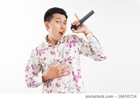 A young man singing karaoke A young man singing karaoke 16650724