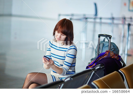Beautiful young female passenger at the airport Beautiful young female passenger at the airport 16658664