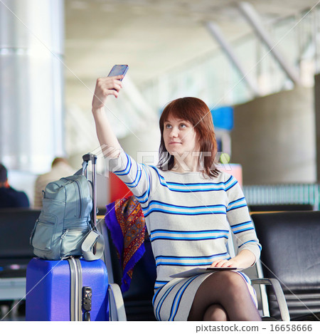 Beautiful young female passenger at the airport Beautiful young female passenger at the airport 16658666