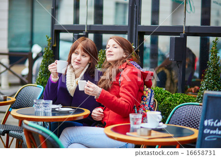 Two beautiful young girls drinking coffee Two beautiful young girls drinking coffee 16658731