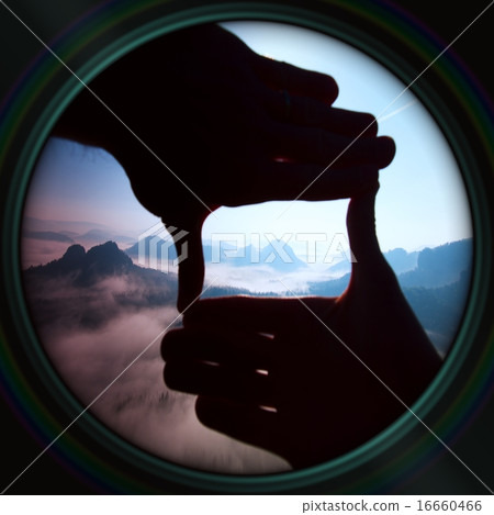 Lens effect. Close up of hands make frame gesture 16660466