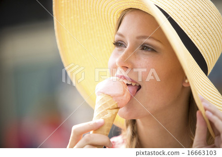 Pretty young girl eating ice cream wearing a hat 16663103