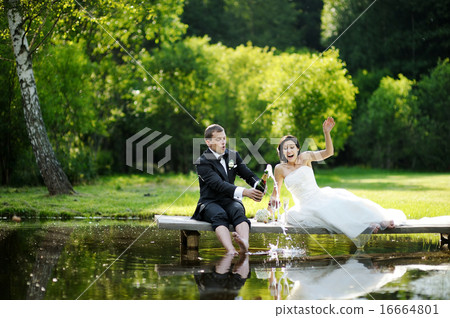 Bride and groom drinking champagne Bride and groom drinking champagne 16664801