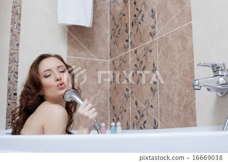 Woman fooling around while singing in bathroom 16669038