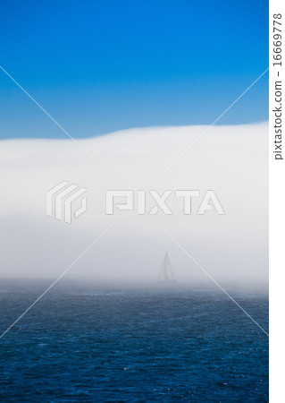 Lonely sailboat in the morning mist Lonely sailboat in the morning mist 16669778