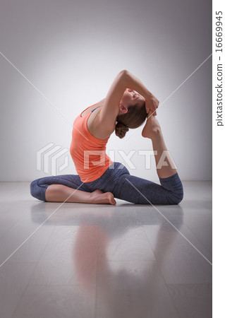 Beautiful sporty fit yogi girl practices yoga asana Eka pada raj 16669945