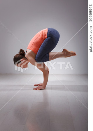 Fit yogini woman practices yoga asana Bakasana Fit yogini woman practices yoga asana Bakasana 16669948