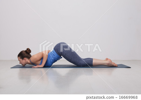 Sporty fit yogini woman practices yoga asana Ashtangasana Sporty fit yogini woman practices yoga asana Ashtangasana 16669968