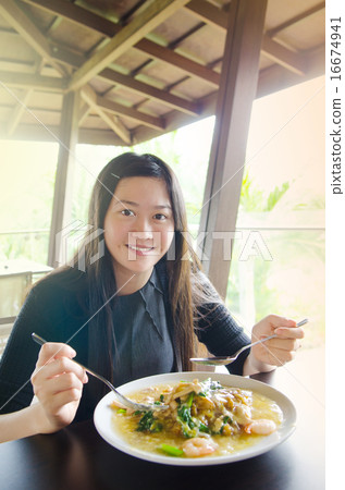 Young asian woman eating noodles Young asian woman eating noodles 16674941