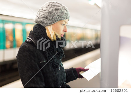 Lady looking on public transport map panel. 16682801