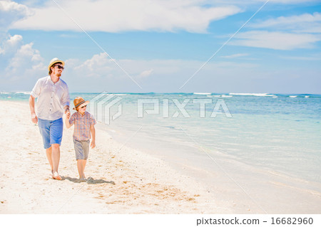 Happy father and his small son having great quality family time enjoying white sand ocean beach on 16682960