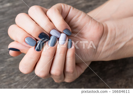 Beautiful hands with the miniature painted in a gray-colored  16684611