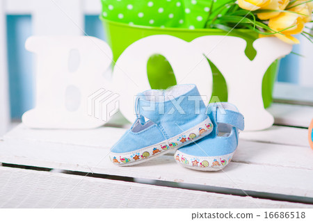Blue baby shoes and flowers Blue baby shoes and flowers 16686518