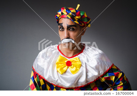 Sad clown against dark background Sad clown against dark background 16700004