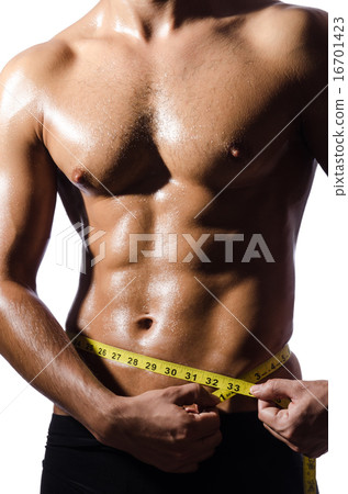 Muscular man measuring his muscles 16701423