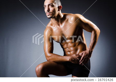 Muscular man in dark studio Muscular man in dark studio 16701426