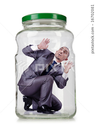 Young businessman in glass jar Young businessman in glass jar 16702081
