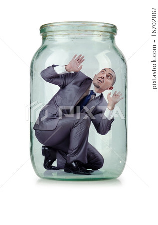 Young businessman in glass jar Young businessman in glass jar 16702082