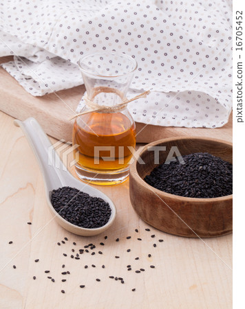 Black sesame oil and sesame seeds . 16705452