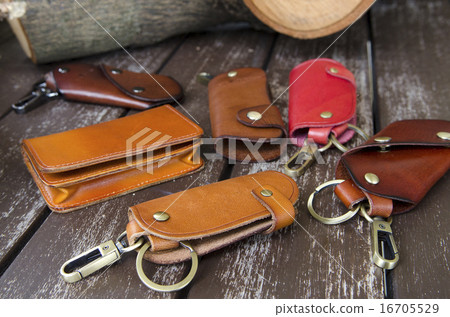 Leather key holders on wooden background 16705529