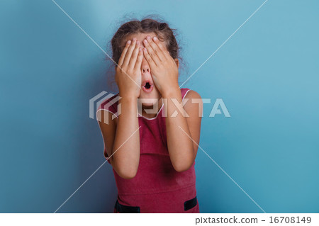 Girl European appearance decade closed eyes with his hands opene 16708149