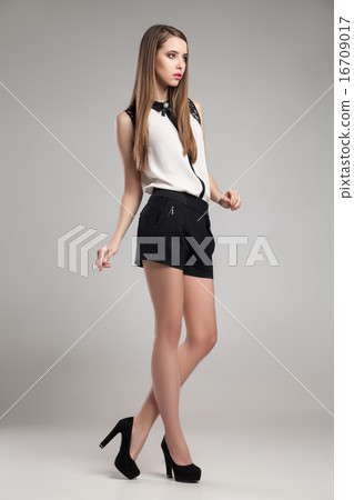 Beautiful woman wearing blouse and shorts  16709017