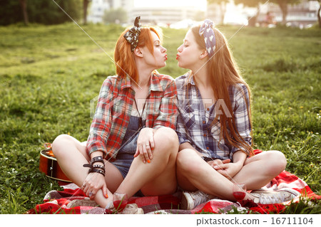Hipster Girls Dressed in Pin Up Style Having Fun Hipster Girls Dressed in Pin Up Style Having Fun 16711104