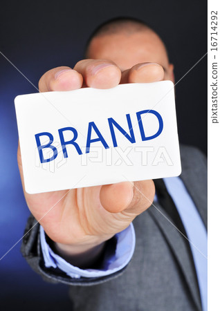 man in suit shows a signboard with the word brand man in suit shows a signboard with the word brand 16714292