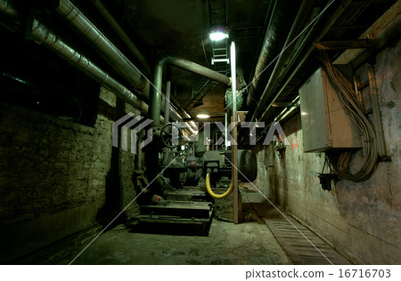 Old abandoned dirty empty scary factory interior 16716703