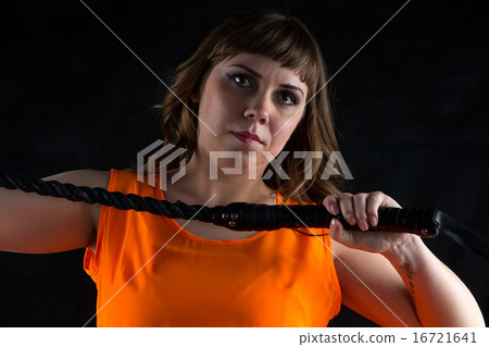 圖庫照片: photo of woman in orange dress with whip