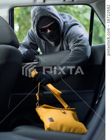 Transportation crime concept .Thief stealing bag from the car 16722682