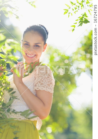 Smiling girl playing in foliage Smiling girl playing in foliage 16724795