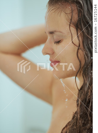 Young woman washing in bathroom Young woman washing in bathroom 16725144