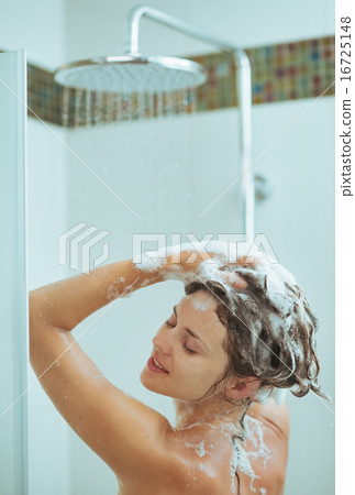 Young woman washing head with shampoo Young woman washing head with shampoo 16725148