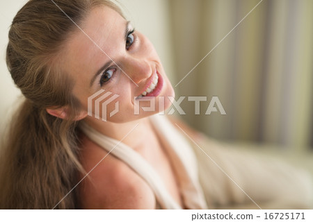 Smiling young woman laying on couch Smiling young woman laying on couch 16725171