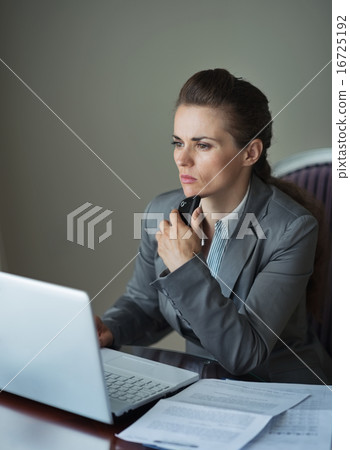 Thoughtful business woman working at hotel room 16725192