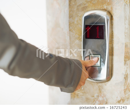 Closeup on business woman hand pushing elevator button Closeup on business woman hand pushing elevator button 16725243