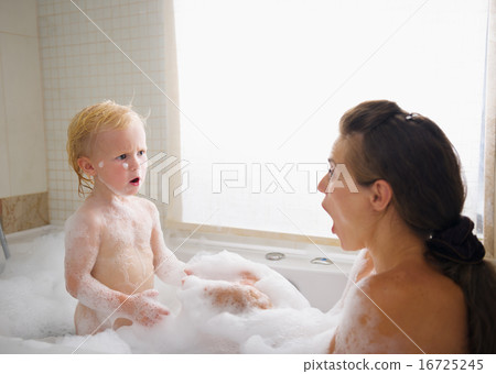 Surprised mother and baby in foam filled bathtub Surprised mother and baby in foam filled bathtub 16725245