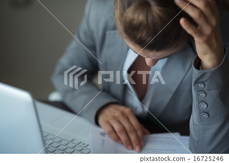 Closeup on stressed business woman working with documents Closeup on stressed business woman working with documents 16725246