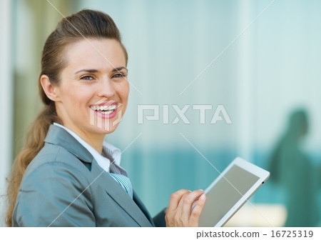 Happy business woman using in tablet PC 16725319