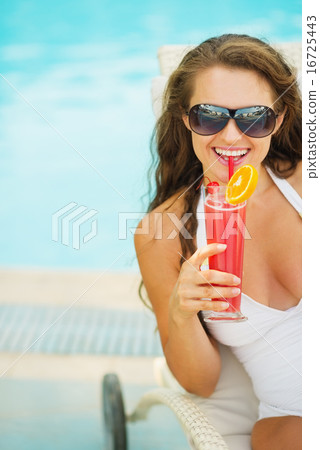 Portrait of happy young woman with cocktail 16725443